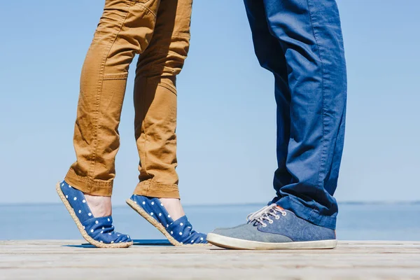 Legs of young hugging couple on the turquoise beach — Stock Photo, Image