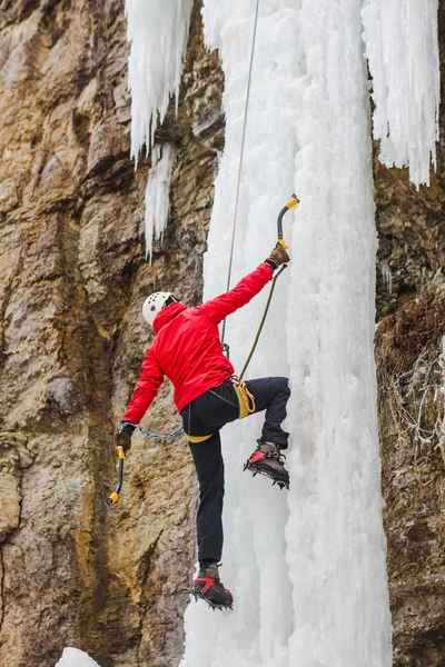 Ice climber climbing a mixed route