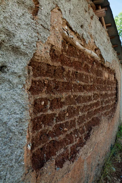 Wall of old adobe house closeup