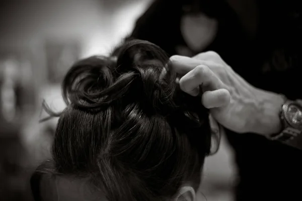 Hairdresser doing a womans hair in monochrome