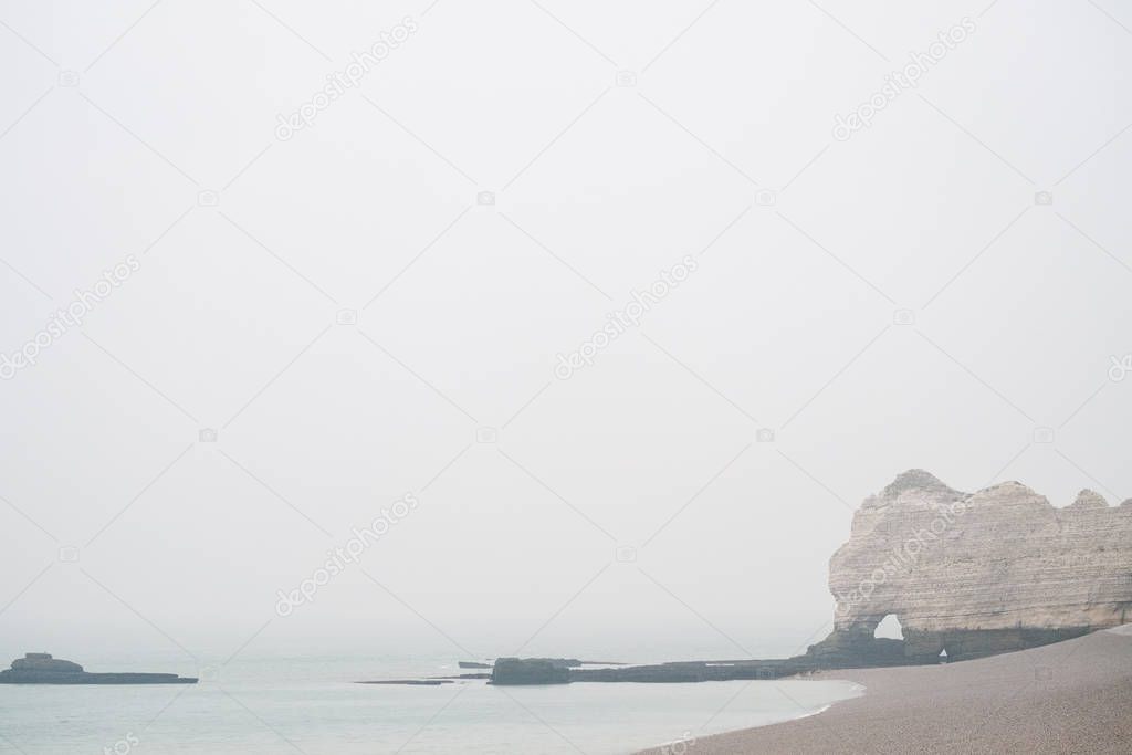 Misty morning fog landscape on the cliffs of Etretat in France