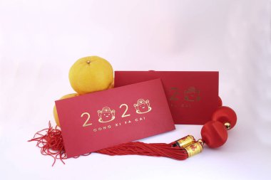 Chinese New Year decorations with white background with assorted festival decorations. Chinese characters means abundant of wealth, prosperity and luck. 2020 Chinese New Year red envelopes `Ang Pow`