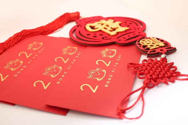 Chinese New Year decorations with white background with assorted festival decorations. Chinese characters means abundant of wealth, prosperity and luck. 2020 Chinese New Year red envelopes `Ang Pow`