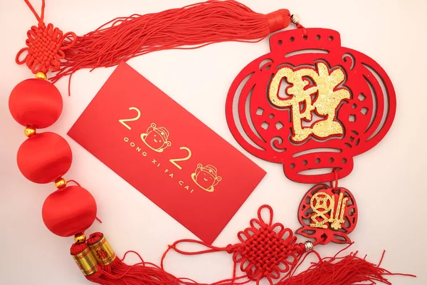 Chinese New Year decorations with white background with assorted festival decorations. Chinese characters means abundant of wealth, prosperity and luck. 2020 Chinese New Year red envelope `Ang Pow`
