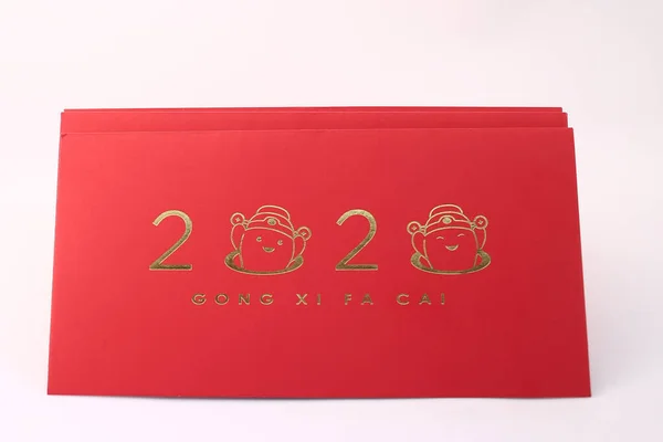 Chinese New Year decorations with white background with assorted festival decorations. Chinese characters means abundant of wealth, prosperity and luck. 2020 Chinese New Year red envelopes `Ang Pow`