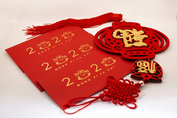 Chinese New Year decorations with white background with assorted festival decorations. Chinese characters means abundant of wealth, prosperity and luck. 2020 Chinese New Year red envelopes `Ang Pow`