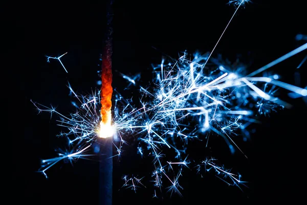 Burning sparkler isolated on black background blur — Stock Photo, Image