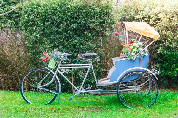 Tricycle in the garden for decorate or take a picture in public — Stock Photo, Image