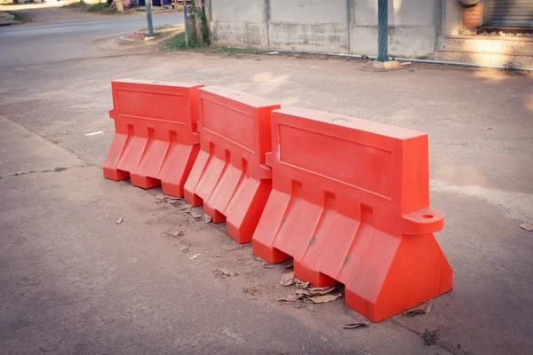 Orange plastic barrier lined up on the road — Stock Photo, Image