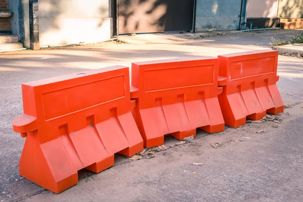 Orange plastic barrier lined up on the road — Stock Photo, Image