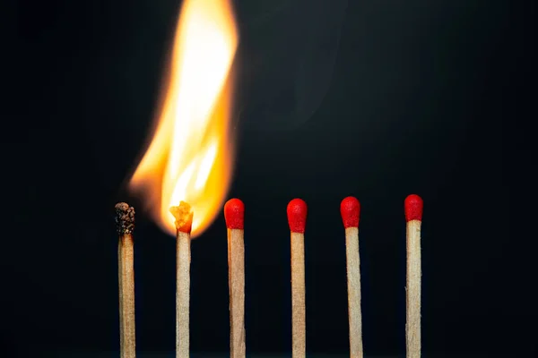 Group match burning on a black background — Stock Photo, Image