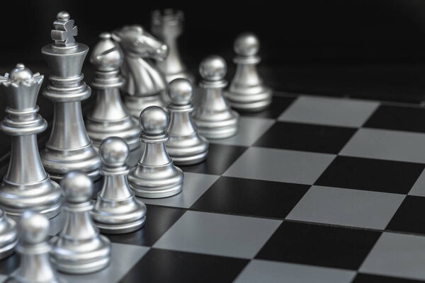 Closeup silver chess on the chess board detail blur art
