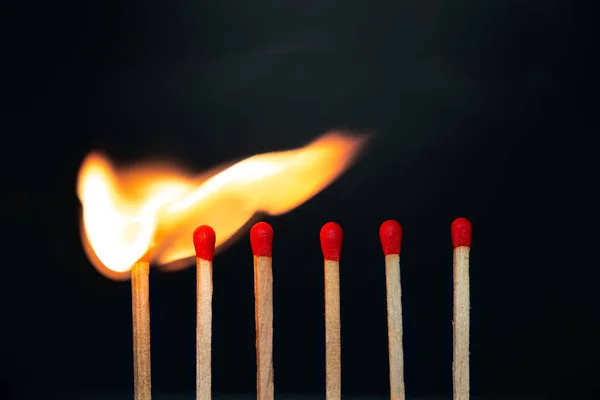 Group match burning on a black background — Stock Photo, Image