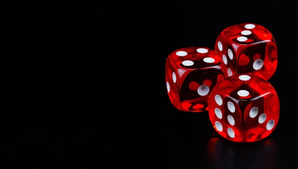 Red dice in dark black background — 图库照片