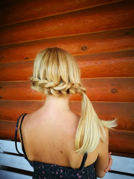 Braided plait on a wooden background. — Stock Photo, Image