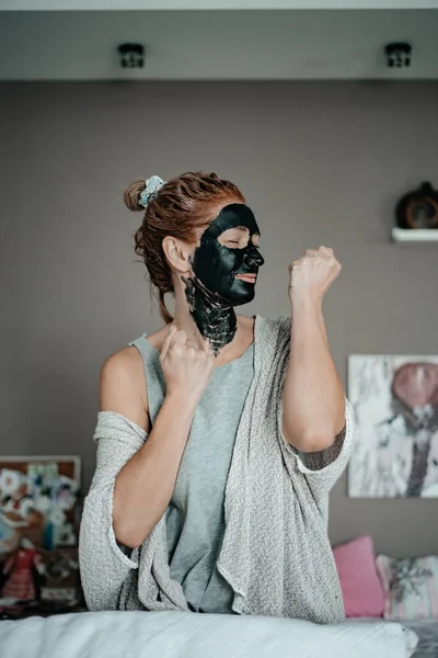 Girl in a black mask. Skin care. Cosmetology