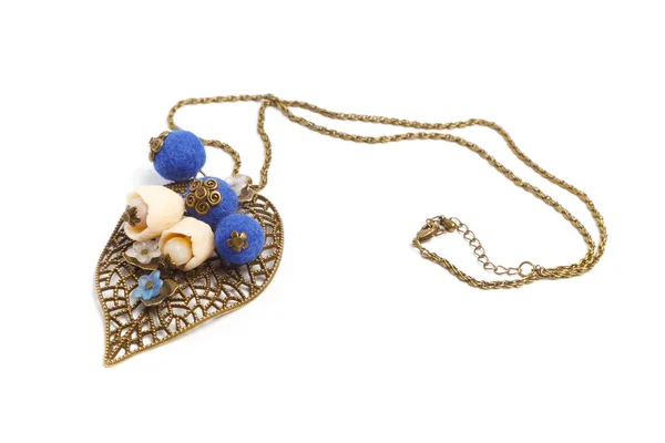Pendant handmade in the form of original blue balls and flowers on a metal leaf