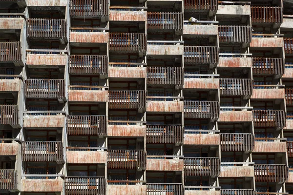 Lattice dilapidated balconies of the standard rooms of the old unfinished hotel