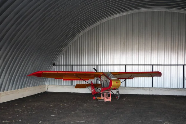 Very Small Single Place Ultralight Glider Stands Corner Metal Hangar — стокове фото