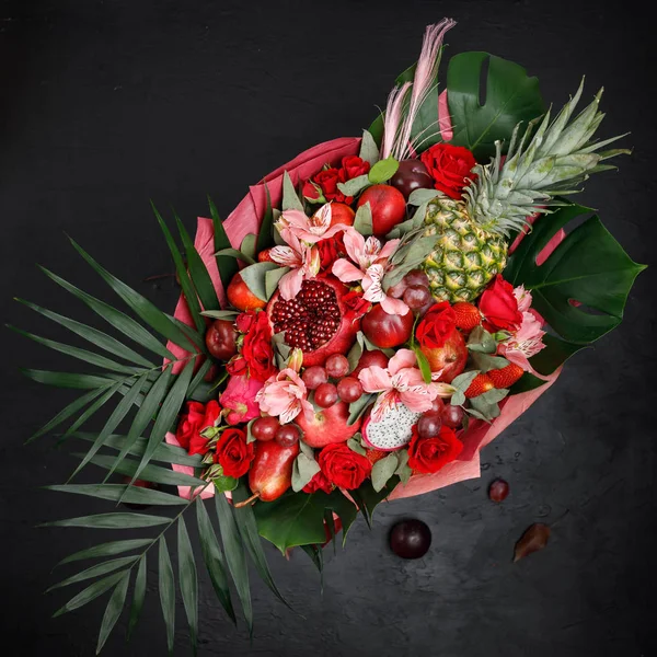 Unusual gift in the form of a bouquet of flowers and fruits. View from above