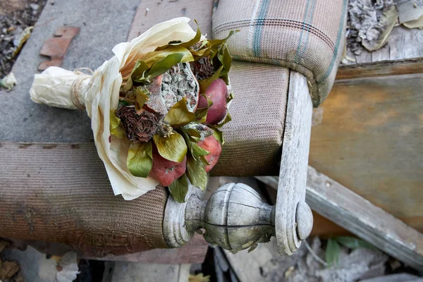 Bunch of rotten fruit and wilted flowers as a symbol of a destroyed old life