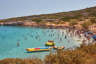 Agios Nikolaos, Greece, August 20, 2013: Small bay with turquoise clear water and a sandy beach