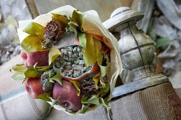 Bouquet of rotten fruit and wilted flowers as a symbol of imminent old age