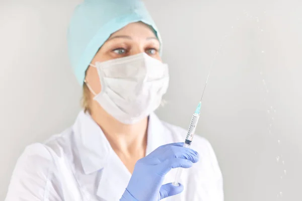 Nurse holding a full syringe with medicine