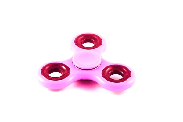 Pink Fidget Spinner en fondo blanco aislado para liberar estrés durante el trabajo —  Fotos de Stock