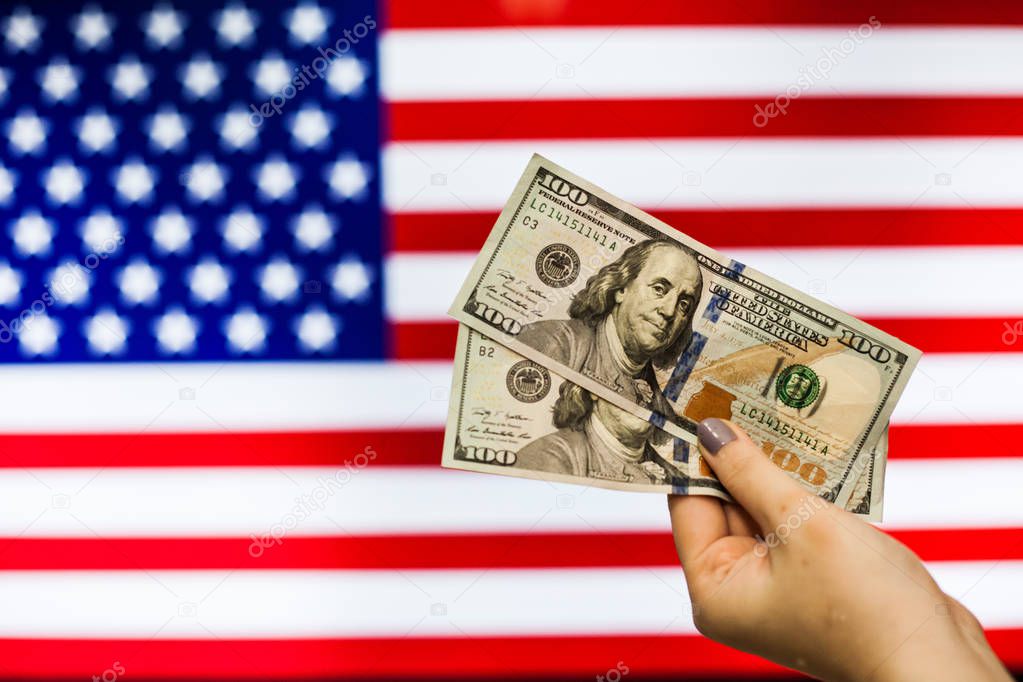 Man holding US Dollar bank note indicating market crash 