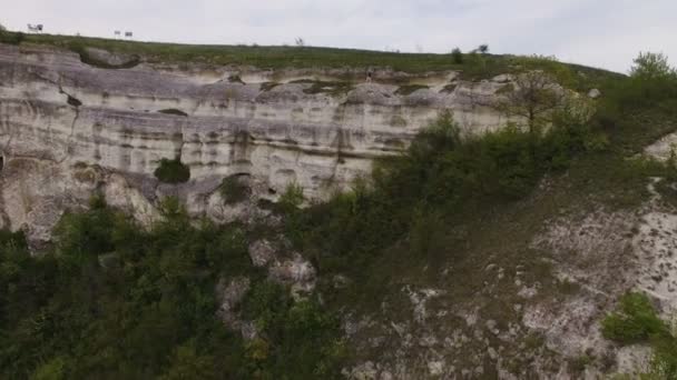 Flygfoto. Dragspelare spela på klipporna. Solnedgång över havet — Stockvideo