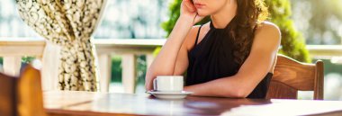 Kahve molası, terasta bir masada oturan bir genç kız nea