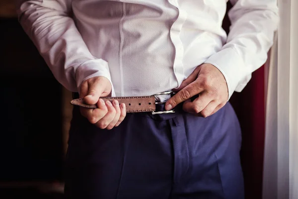 man putting on a belt, Businessman, Politician, man's style, male hands closeup, American businessman, European businessman, a businessman from Asia, People, business, fashion and clothing concept