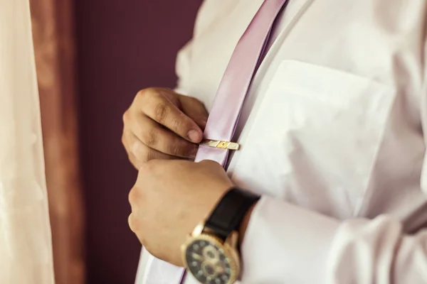 People, business, fashion and clothing concept - close up of man in shirt dressing up and adjusting tie on neck at home. Businessman putting on a tie. Man putting on necktie. Businessman getting dressed in the morning — Stock Photo, Image