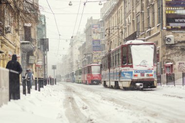 Lviv, Ukrayna - 13 Kasım 2016: street Lviv karla kaplı. Kar yağışı, karla kaplı araba. Karda tramvay. Lviv, Ukrayna