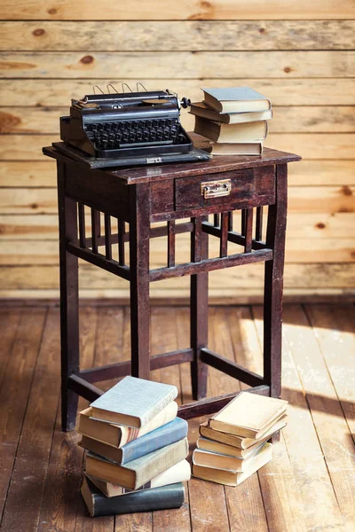 Máquina de escribir y libros sobre la mesa, máquina de escribir vintage y libros antiguos, vintage, área de escritor, máquina de escribir, máquina de escribir vieja con papel en blanco en escritorio de madera, llaves de máquina de escribir vieja, antigüedades, retro — Foto de Stock
