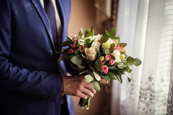 bridal bouquet in hands, wedding bouquet in hands of the groom, groom morning, businessman, wedding, man fashion