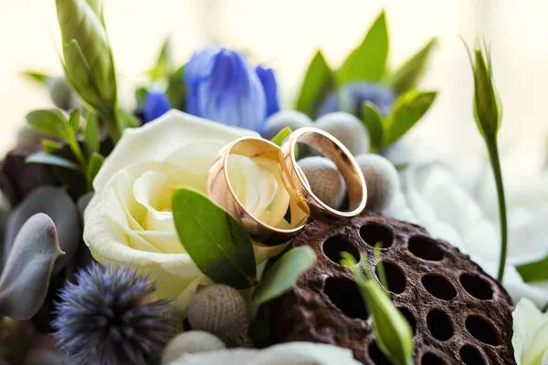 Wedding rings lie on a beautiful wedding bouquet, wedding rings lie on a roses, bridal accessories, European Wedding, American Wedding Stock Image