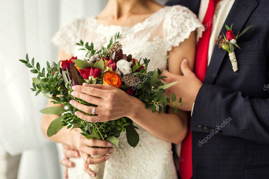 the bride holding a wedding bouquet in the hands of a wedding bouquet and hands closeup, wedding accessories, wedding