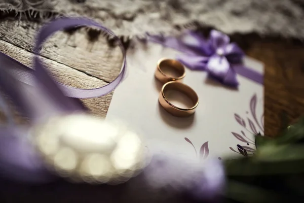 Wedding rings are on the table, wedding and engagement ring together. wedding accessories,wedding invitation