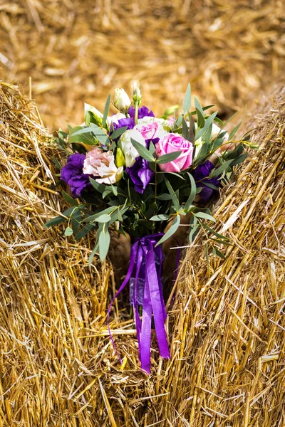 beautiful bridal bouquet lying on the haystack,beautiful bridal bouquet , bridal accessories, wedding European, American Wedding