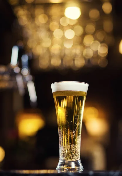 Beer, a glass of fresh cold beer on the bar.A pub.Bar.Restaurant.Classic.Evening.European restaurant.European bar.American restaurant.American bar.strong drin