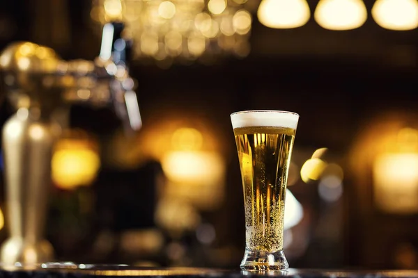 Beer, a glass of fresh cold beer on the bar.A pub.Bar.Restaurant.Classic.Evening.European restaurant.European bar.American restaurant.American bar.strong drin