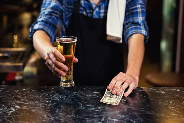 Bartender pouring the fresh beer in pub,barman hand at beer tap pouring a draught lager beer,beer from the tap,Filling glass with beer,fresh beer,pub.Bar.Restaurant.European bar.American bar.