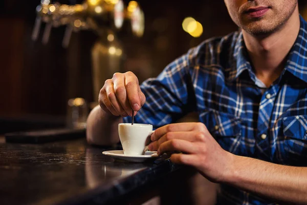 handsome young man drinking coffee while sitting at bar counter.enjoying coffee,Cafe Coffee Caffeine Casual Relaxation Style Concept.Young fashion man drinking espresso coffee in city cafe