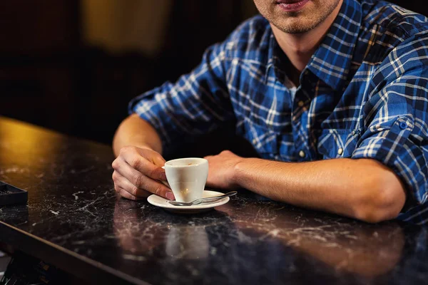 handsome young man drinking coffee while sitting at bar counter.enjoying coffee,Cafe Coffee Caffeine Casual Relaxation Style Concept.Young fashion man drinking espresso coffee in city cafe