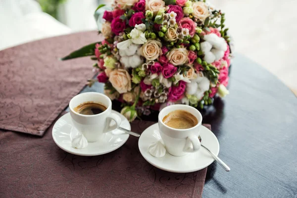 loving couple drinking coffee in a coffee shop,meeting in a cafe, a beautiful bouquet,coffee concept