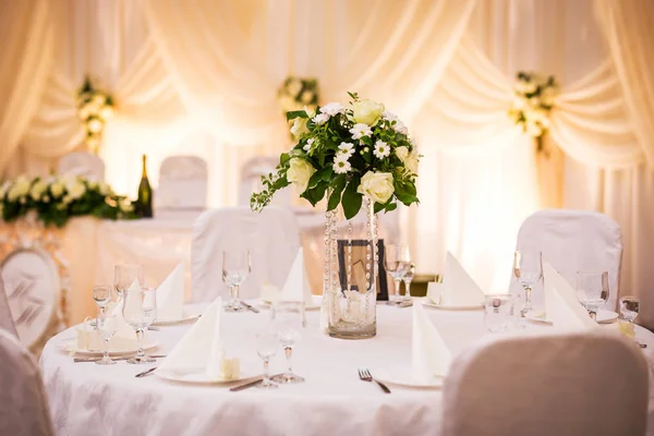 Plate at the wedding table,Wedding table settings.Wedding table that decorated with flower arrangements,Wedding. Banquet.Wedding flower composition for guests tables