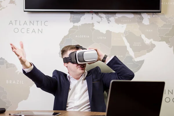 Man wearing virtual reality goggles,Businessman making gestures when wearing virtual reality goggles,virtual reality goggles concept,Smartphone using with VR headset,Future technology concept