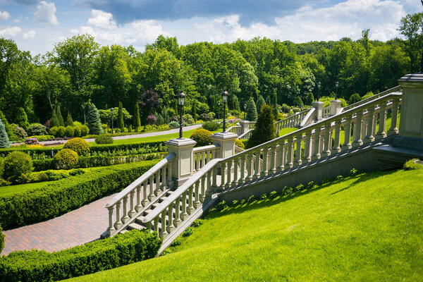 Landscaping in the garden. The path in the garden.Beautiful backyard landscape design,Some flowers and nicely trimmed bushes on the leveled front yard,Landscape formal